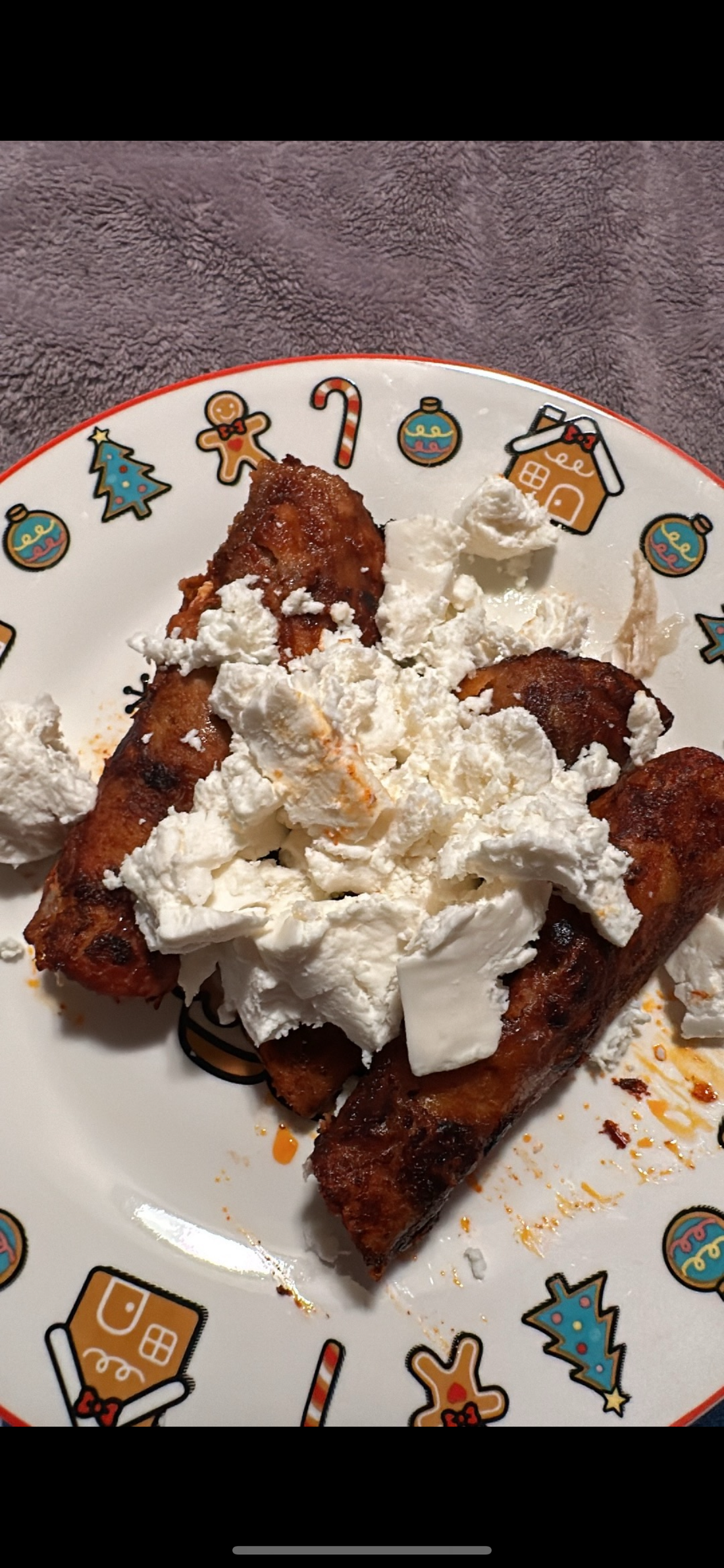 Corn tortillas being dipped in red enchilada sauce for authentic Mexican enchiladas